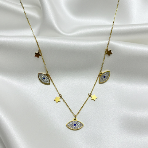 Gold necklace with eye-shaped pendants and star accents on a satin surface